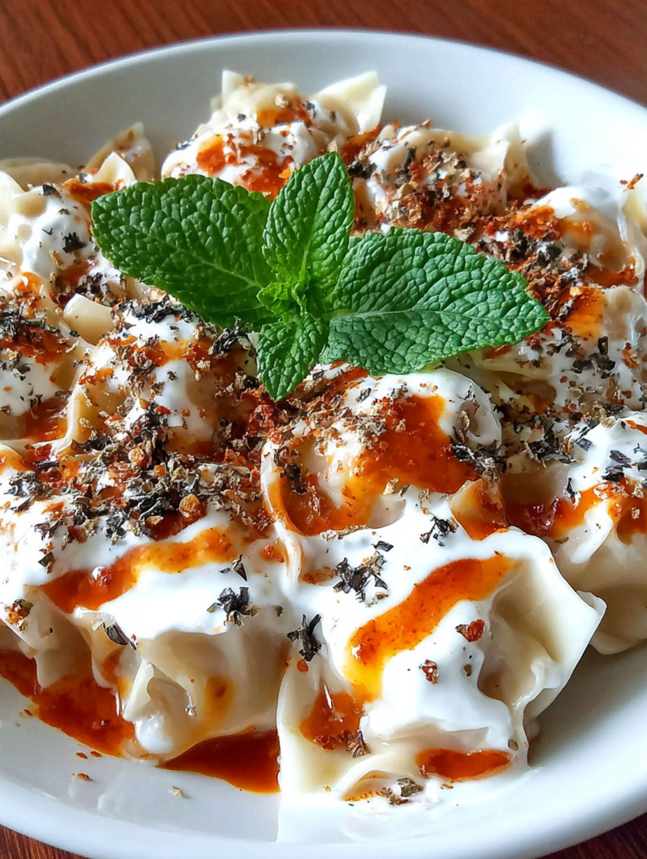 A plate of food with a mint leaf on top.