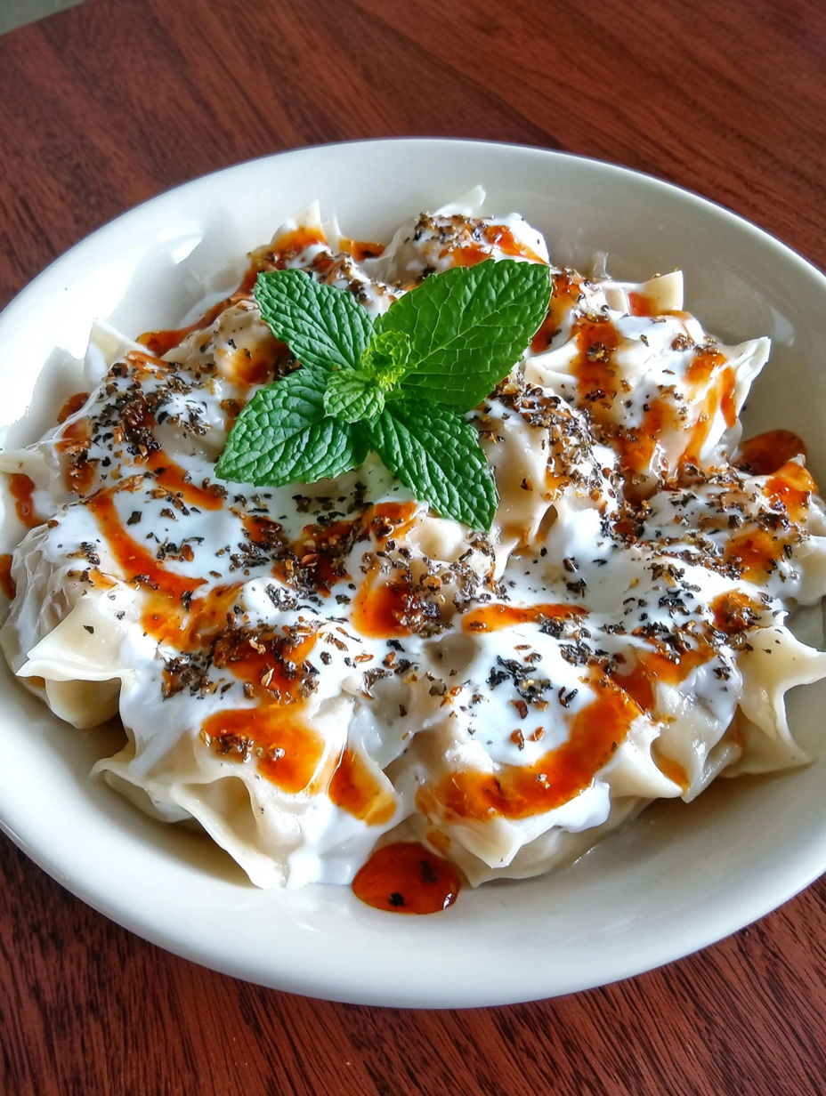 A bowl of food with a green leaf on top.