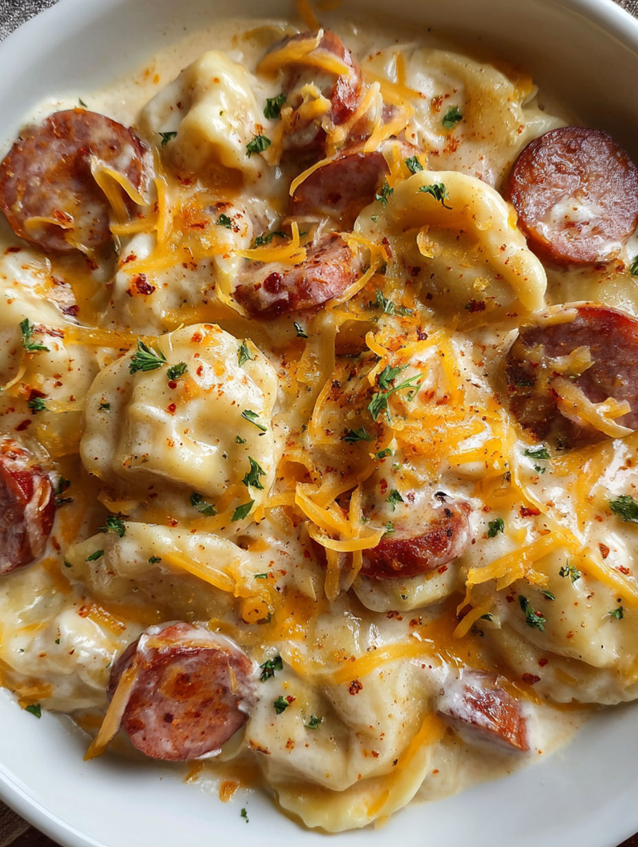 A plate of food with a sausage on top.