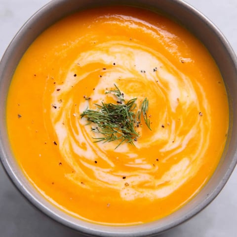 A bowl of soup with a spoon in it.