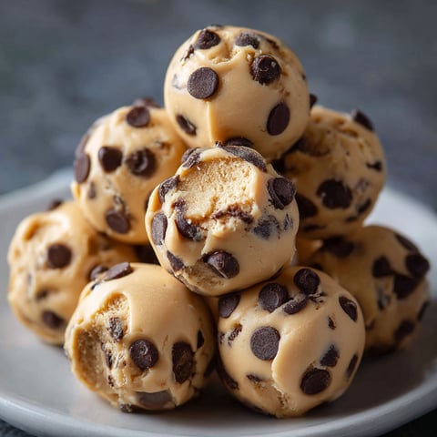 A plate of chocolate covered peanut butter balls.
