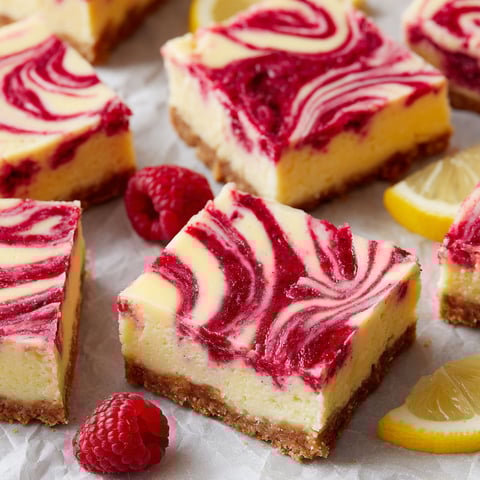 A slice of Raspberry Lemonade Cheesecake Bars.