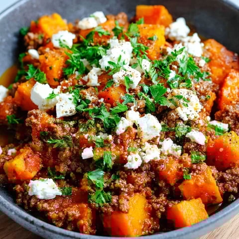 A bowl of food with feta cheese on top.