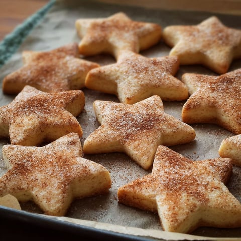 A tray of cookies with sugar and cinnamon.