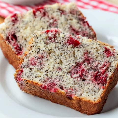 A slice of cherry almond poppyseed quick bread.