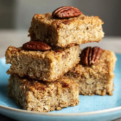 A stack of banana bread with nuts on top.